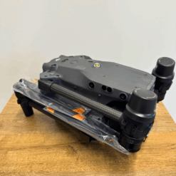 Grey drone folded on wooden table.