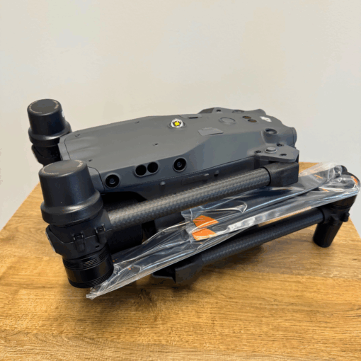 Drone folded on a wooden table.