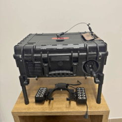 Black case with electronic equipment on wooden table.