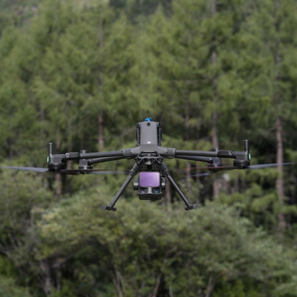 Drone flying in front of trees.