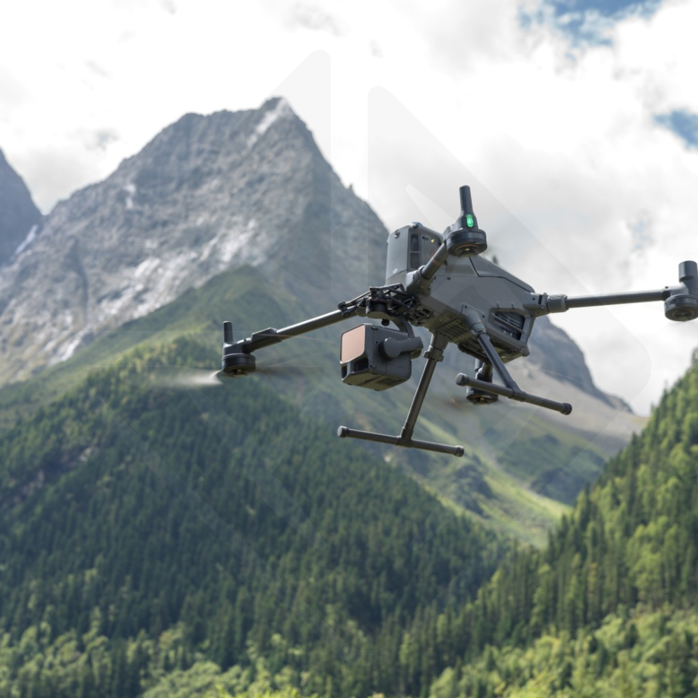 Drone flying in front of green mountains.