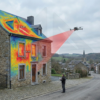 Drone measuring the temperature of a house with thermography.