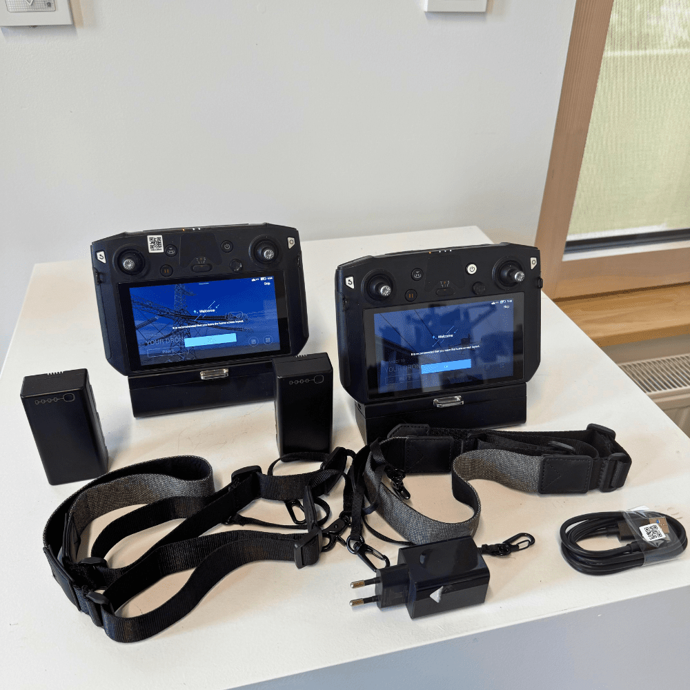 The two DJI remote controllers with straps and charger
