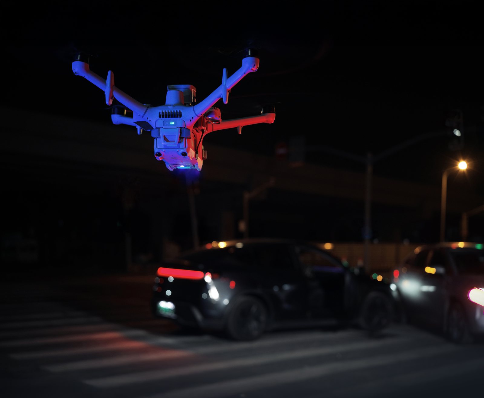 DJI Matrice 5TD at night with red and blue warning lights